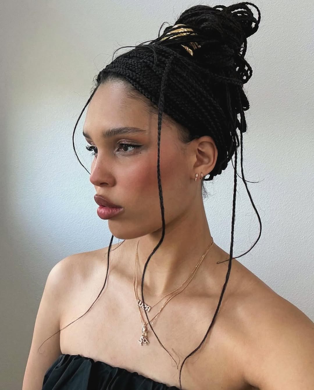 Nara Smith wears her knotless braids in a messy updo with Lelet NY's Glossy Double Arch Pony