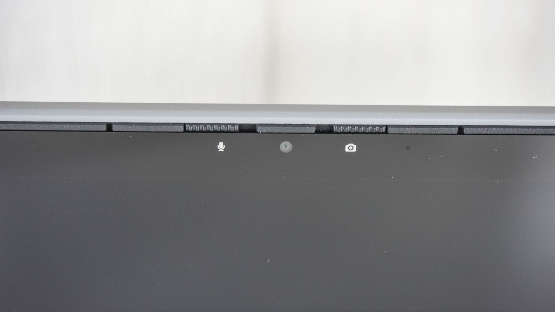 A close-up shot of the Framework Laptop 12's webcam with its camera and microphone shutters clearly visible