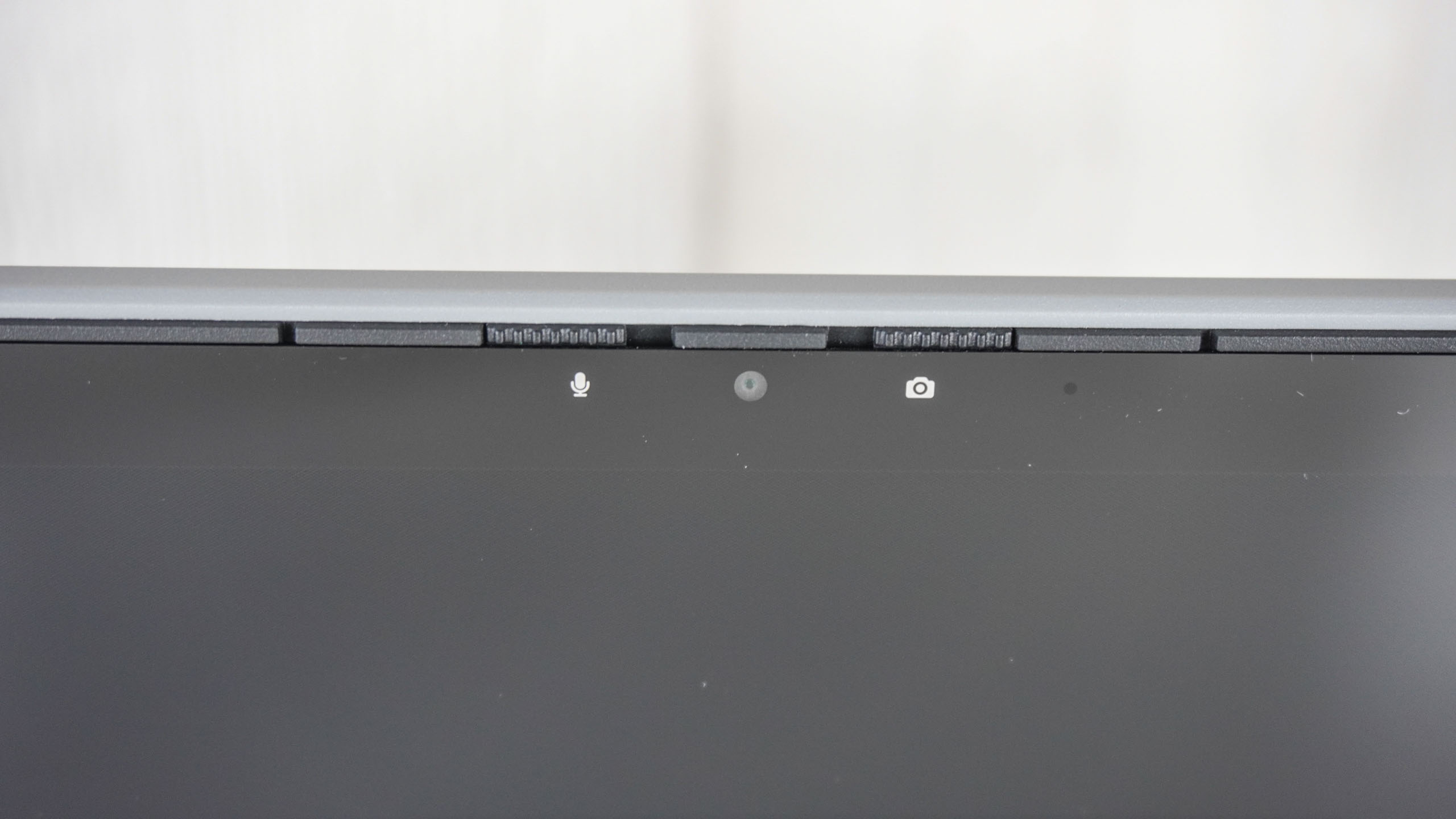 A close-up shot of the Framework Laptop 12's webcam with its camera and microphone shutters clearly visible
