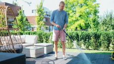 man cleaning patio