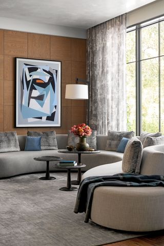Living room with neutral colors gray curved sectional sofa