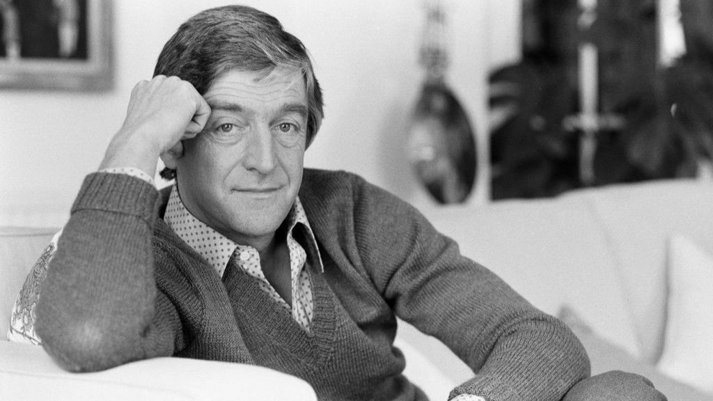 The broadcaster Michael Parkinson sitting on a sofa in 1981.