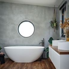 Grey bathroom with round bath tub 