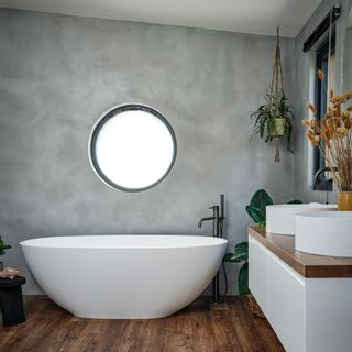 Grey bathroom with round bath tub