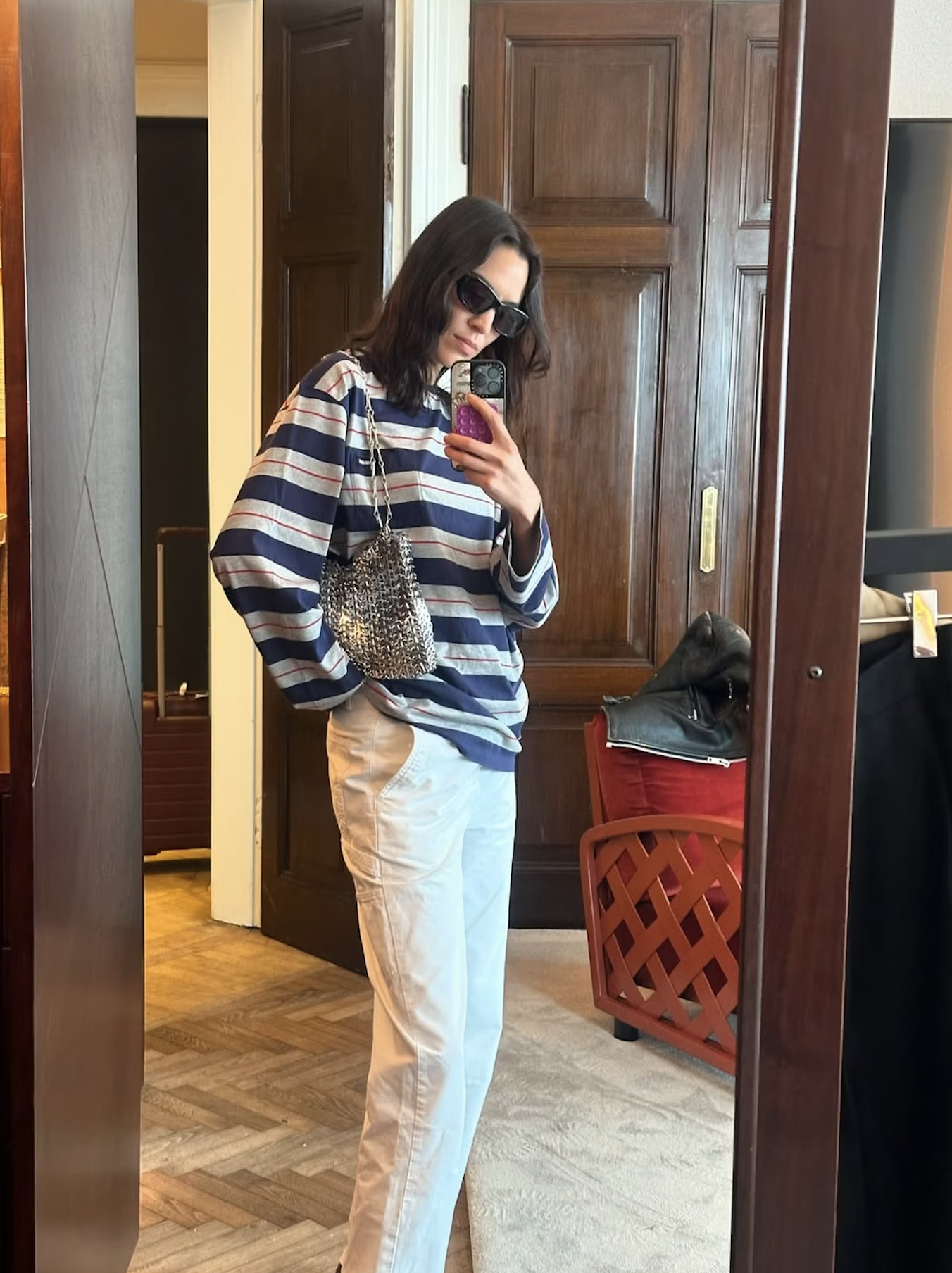 Alexa Chung wears a striped top with white jeans