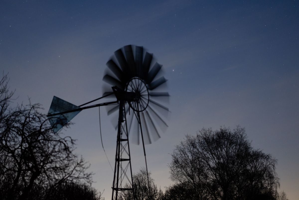 A wind pump at night shot with a Canon RF 85mm f/1.2L USM lens