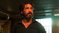 A bearded Jon Bernthal looks upset in a dingy looking room in Daredevil: Born Again.