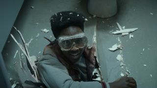 Caleb McLaughlin's Lucas coming through the floor wearing goggles