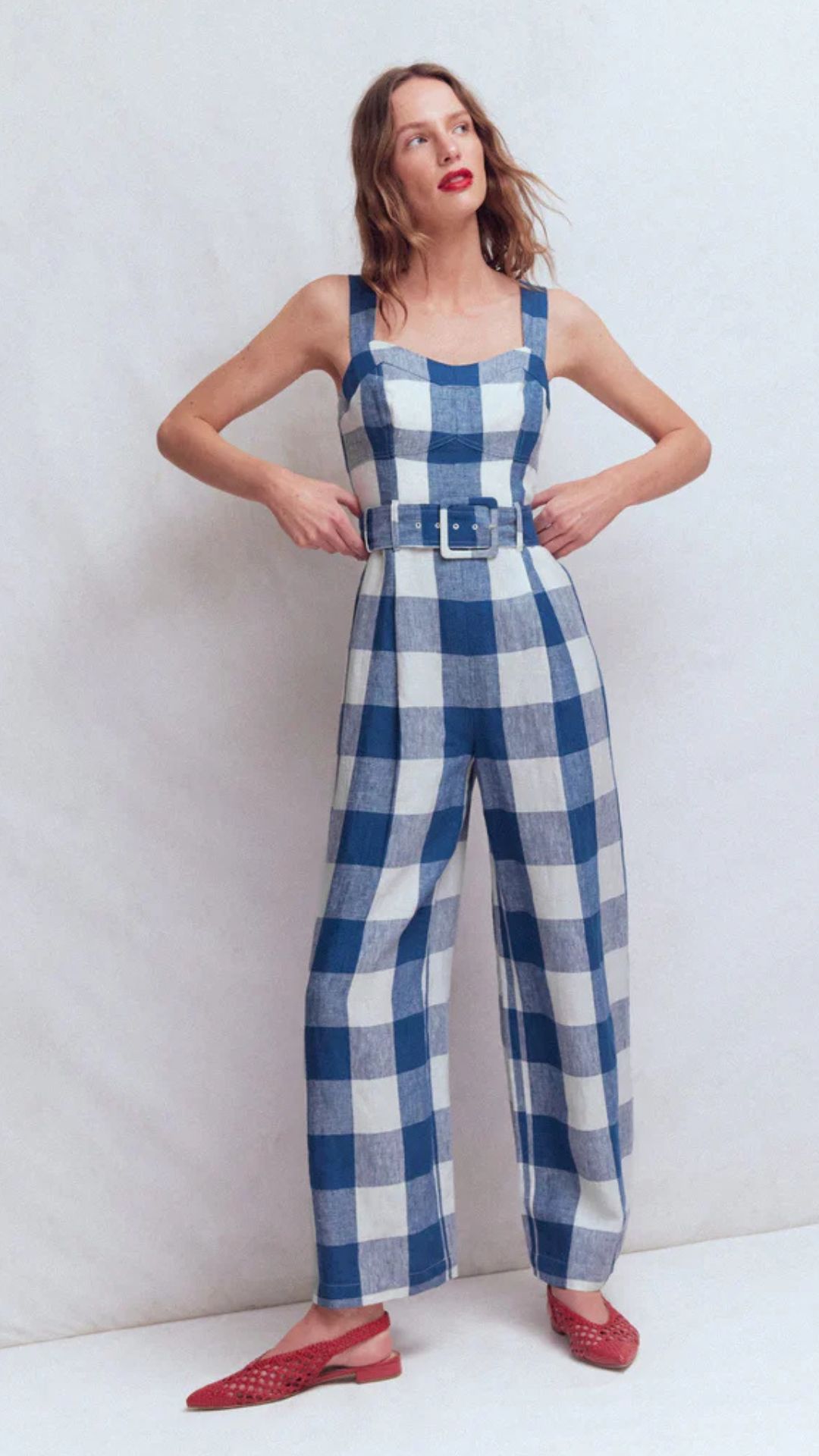 a model wearing the boden jumbo gingham jumpsuit