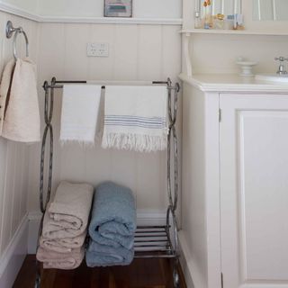 bathroom with towels hanging on rack and wall panelling