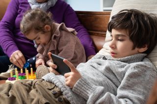 child on smartphone gaming