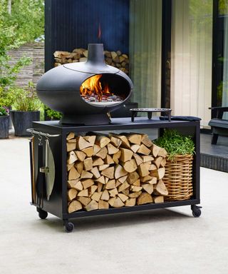 Morso pizza oven on stand with log storage