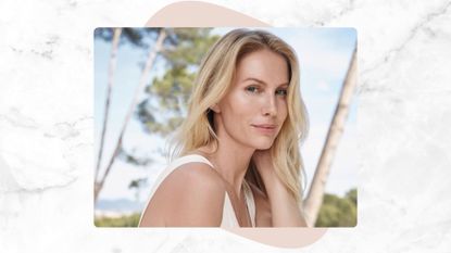 marble backdrop with an image of a blonde woman, with smooth skin, wearing a white dress with a blue sky and trees behind her