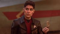 Ortegas looks around with her communicator. 