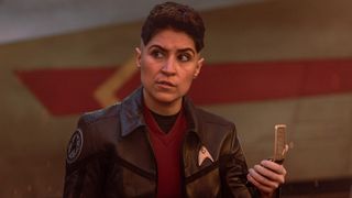 Ortegas looks around with her communicator. 