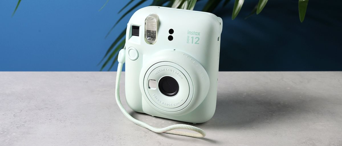 A mint green Fujifilm Instax mini 12 instant camera