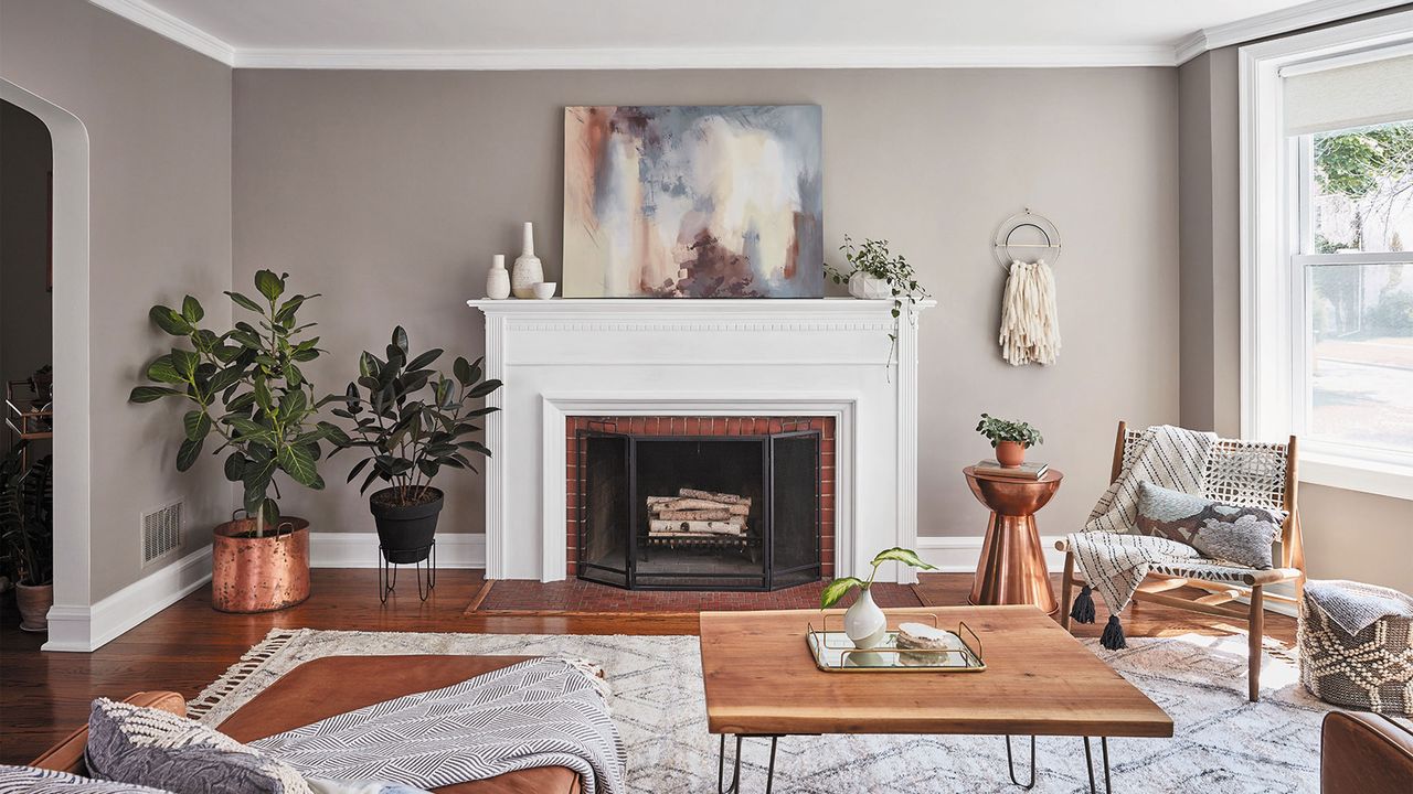 Beige living room with house plants and fireplace