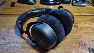 A Beyerdynamic MMX 150 Wireless gaming headset on a wooden desk