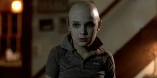 Corey Feldman stands with a shaved head in Friday the 13th: The Final Chapter.