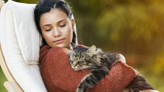 a woman peacefully naps with her cat