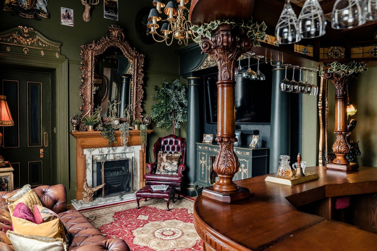 The house includes a bar in the design of a pub with a fireplace and Chesterfield sofas