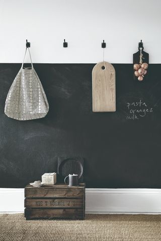 A blackboard wall featuring practical hooks for storage