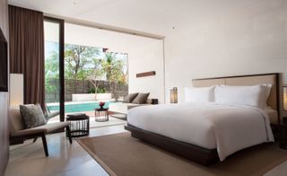 An image of the guest room with a view of the private pool