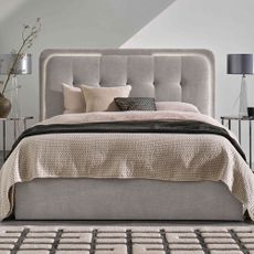 White bedroom with grey upholstered bed