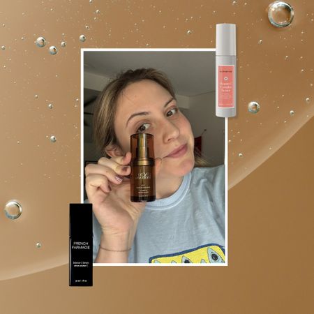 a brown-orange serum texture background with a girl in a grey shirt holding a brown serum next to a grey and pink serum and a black serum skincare bottle.