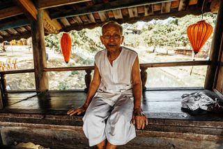 Asian man in Vietnam sitting on a bridge travel photography