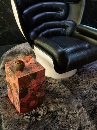A leather chair with side table