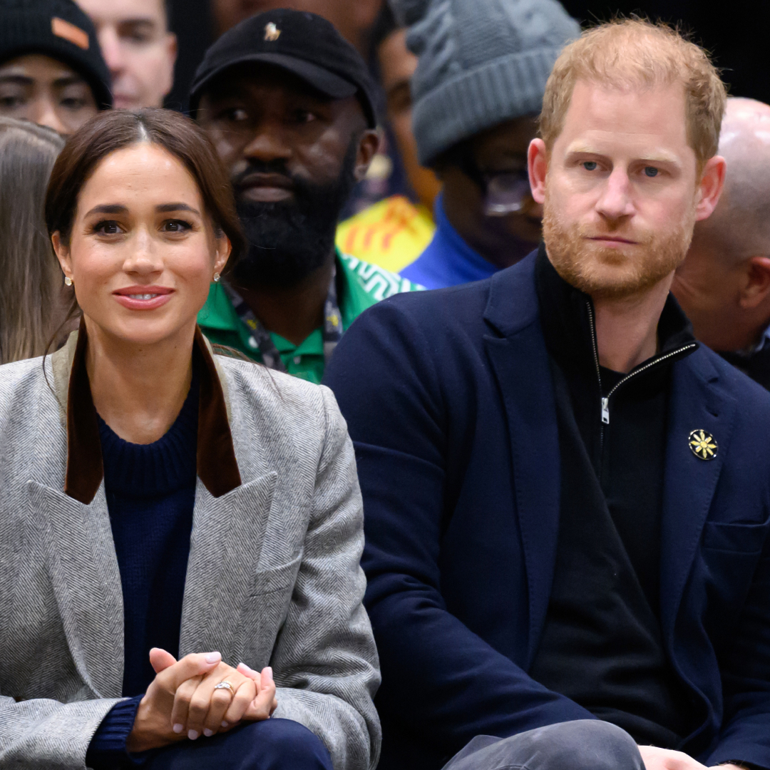 Meghan Markle and Prince Harry sitting in the audience at Invictus Games wearing blazers