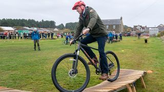 The future King, Prince William riding a wooden berm on an MTB