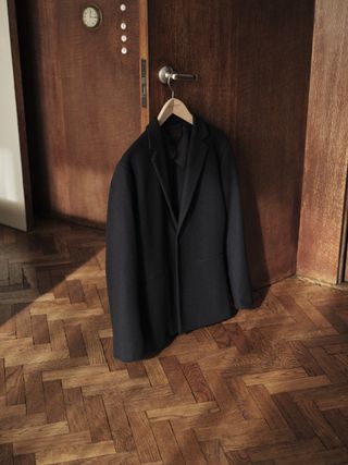Sunspel and Casely-Hayford suit jacket hanging on doorway