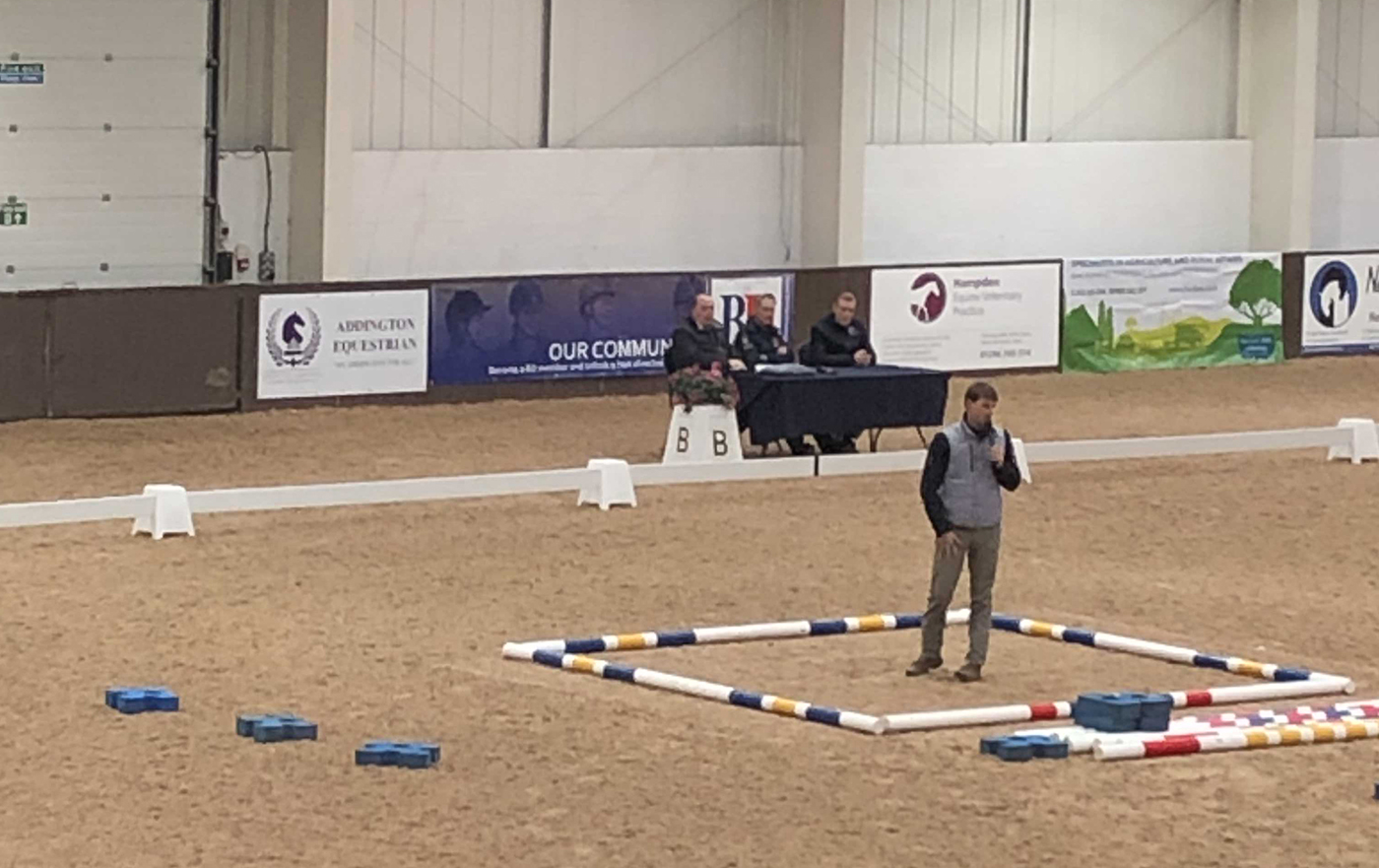 Michael Eilberg demonstrates scales of training using poles laid out in a square