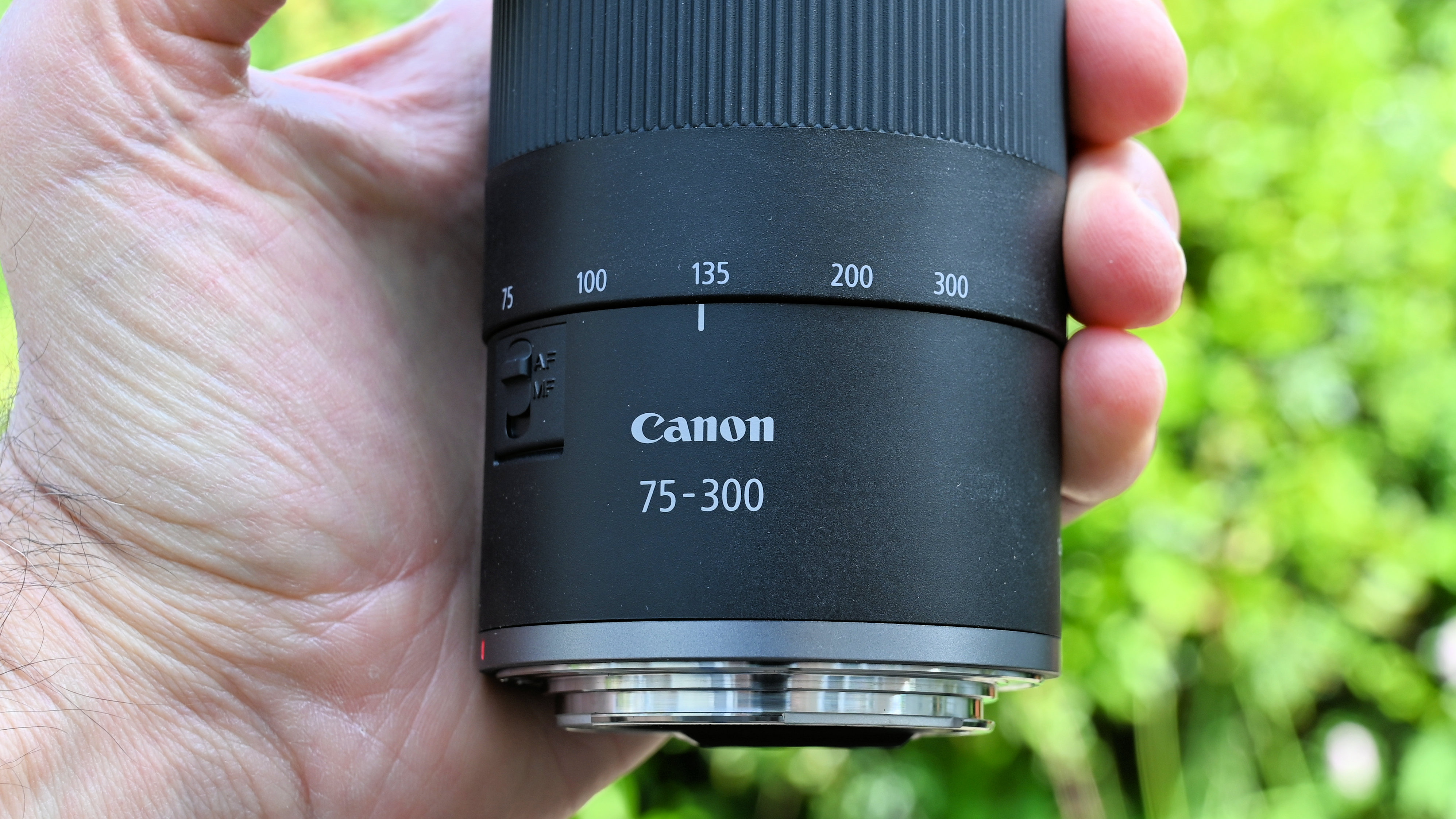 Canon RF 75-300mm f/4-5.6 product shot held in hand