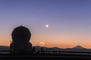 The crescent moon and Venus appear with an Auxiliary Telescope of the Very Large Telescope at ESO's Paranal Observatory in Chile. Image released April 18, 2016.