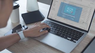 A person sat at a computer blocking a spam email