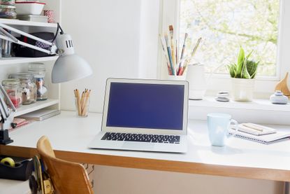 Laptop on table at home, place of work, closet office