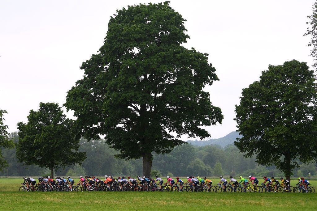FRAUENFELD SWITZERLAND JUNE 06 Trixi Worrack of Germany and Team Trek Segafredo Elise Chabbey of Switzerland and Team Canyon SRAM Racing Yellow Leader Jersey Marta Bastianelli of Italy and Ale Btc Ljubljana Team Audrey CordonRagot of France and Team Trek Segafredo The peloton passing through a landscape during the 1st Tour de Suisse Women 2021 Stage 2 a 98km stage from Frauenfeld to Frauenfeld Rain tourdesuisse tds tdswomen on June 06 2021 in Frauenfeld Switzerland Photo by Tim de WaeleGetty Images