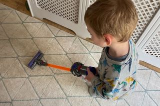 Four year old Max playing with the Casdon Dyson Cordless Vacuum