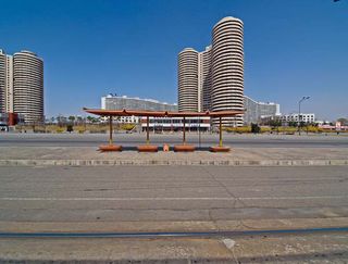 The head of Kwangbok Street is marked by cylindrical residential towers and wave-shaped housing slabs