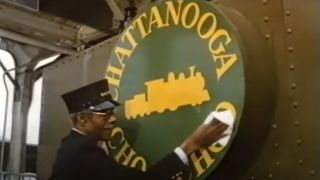 A man wiping down a sign that says Chattanooga Choo Choo