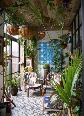 a small sunroom with lots of plants
