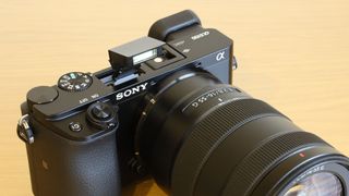 A Sony A6100 on a table, one of the best cheap cameras