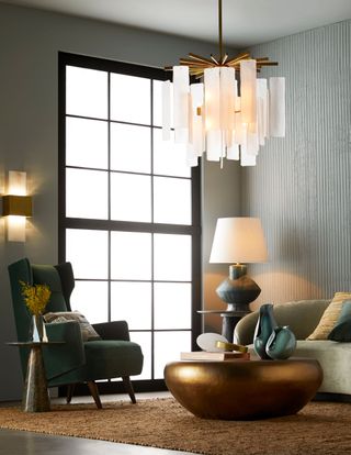 grey living room with fluted concrete wall and brass and metallic accessories by Arteriors