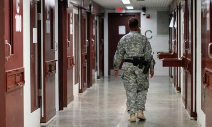 A guard walks through a cellblock on March 5 inside Camp V, Guantanamo Bay.