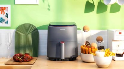 Image of Cosori Lite air fryer on countertop in promo image 