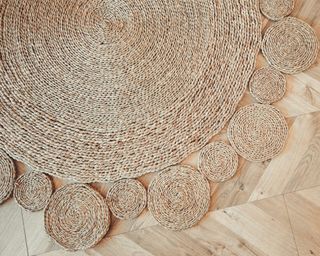 Close up of round jute rug on wooden floor