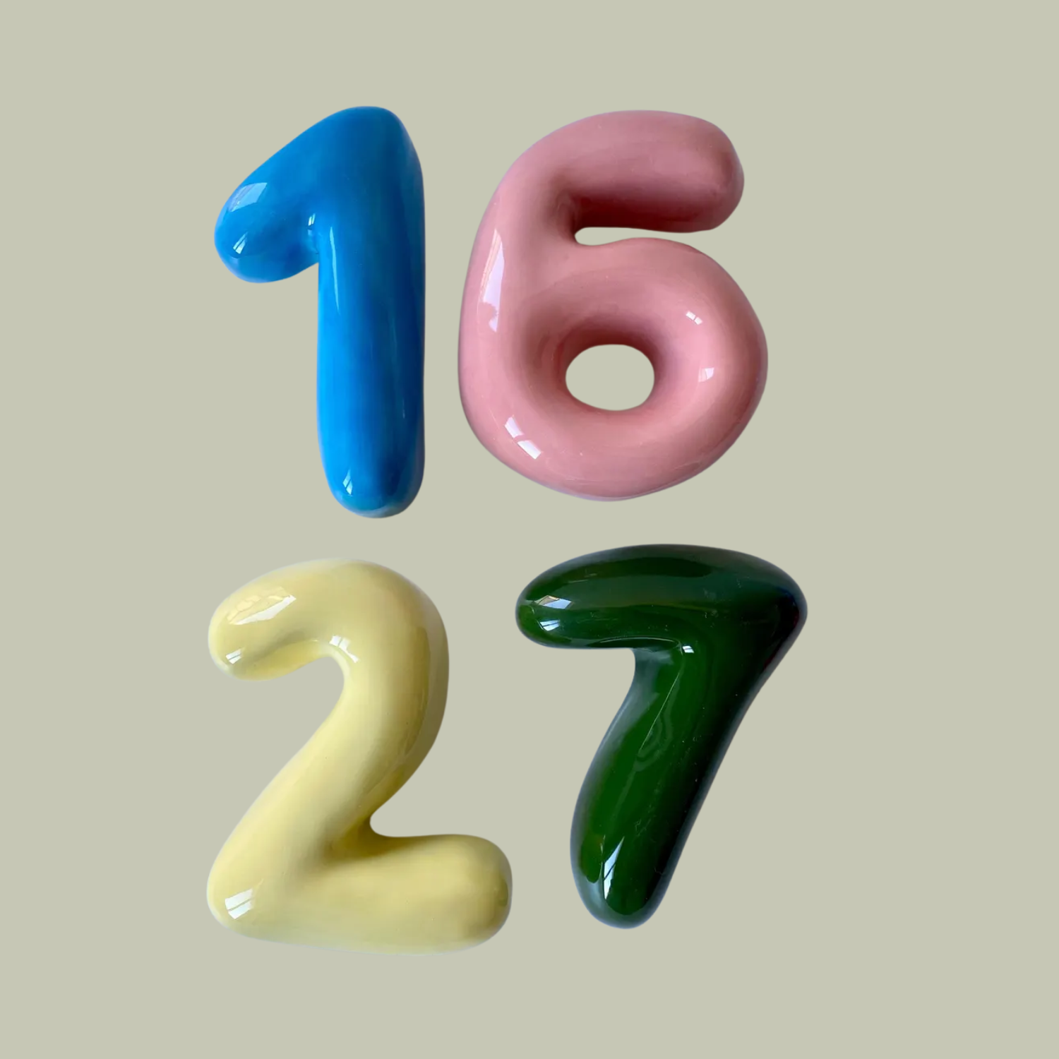 A set of four colorful ceramic bubbled door numbers